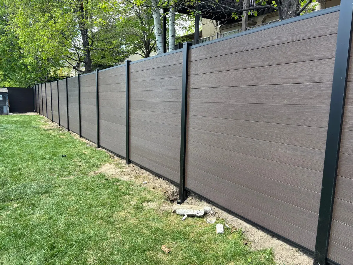 Composite fence panels along a green lawn